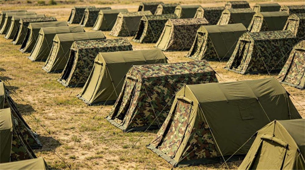 Military camouflage tent camp for field deployment and troop accommodation