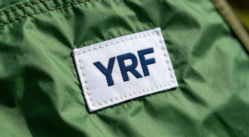 Custom branding photograph showing blank label area on blue tent tarpaulin material ready for custom logo printing, demonstrating private label and OEM branding capability for relief tent wholesale and export orders