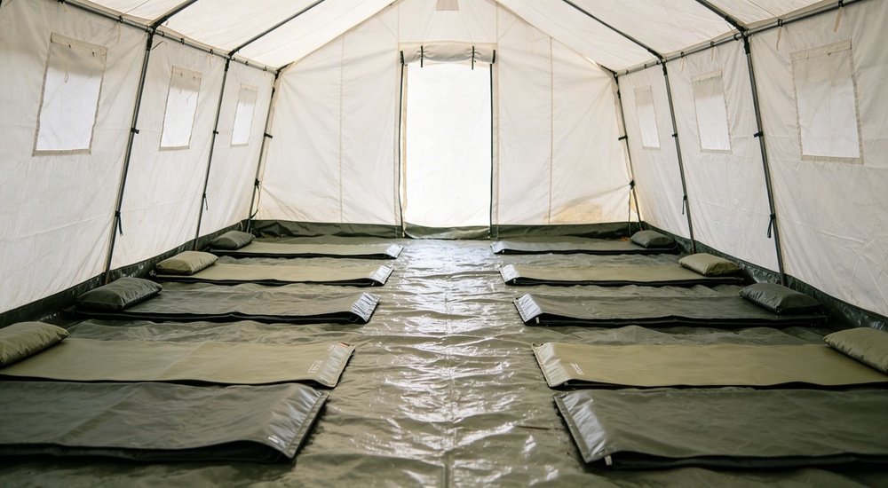 Related product display showing emergency floor mats and ground covers compatible with relief tent tarpaulin systems, blue and grey mat samples visible showing complementary products for complete emergency shelter flooring solution