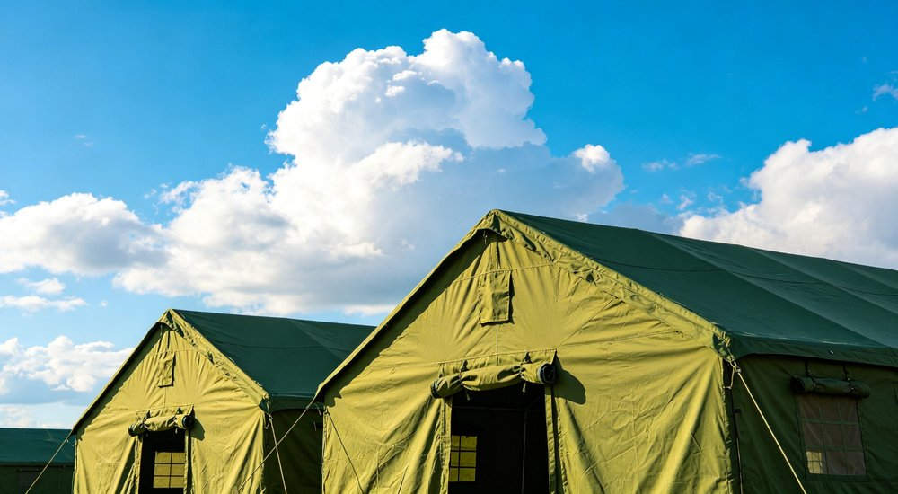 Field deployed emergency shelter showing robust frame construction waterproof material and practical design features meeting international standards for disaster response and refugee accommodation