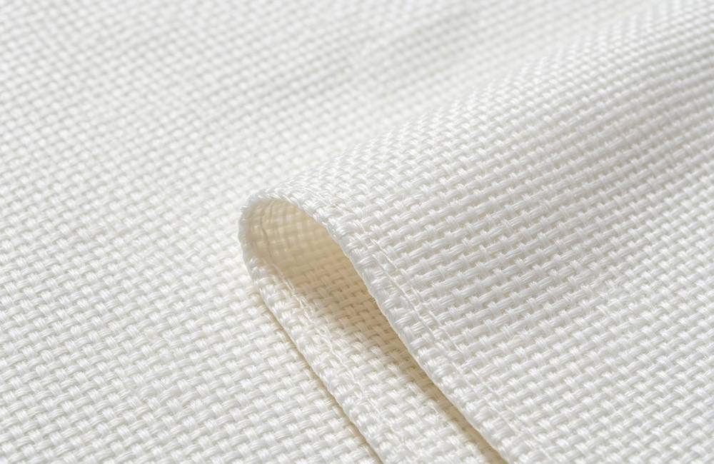 Close up woven glass fiber fire blanket texture showing tight weave and 550 degree heat resistance for bulk fire blanket orders today
